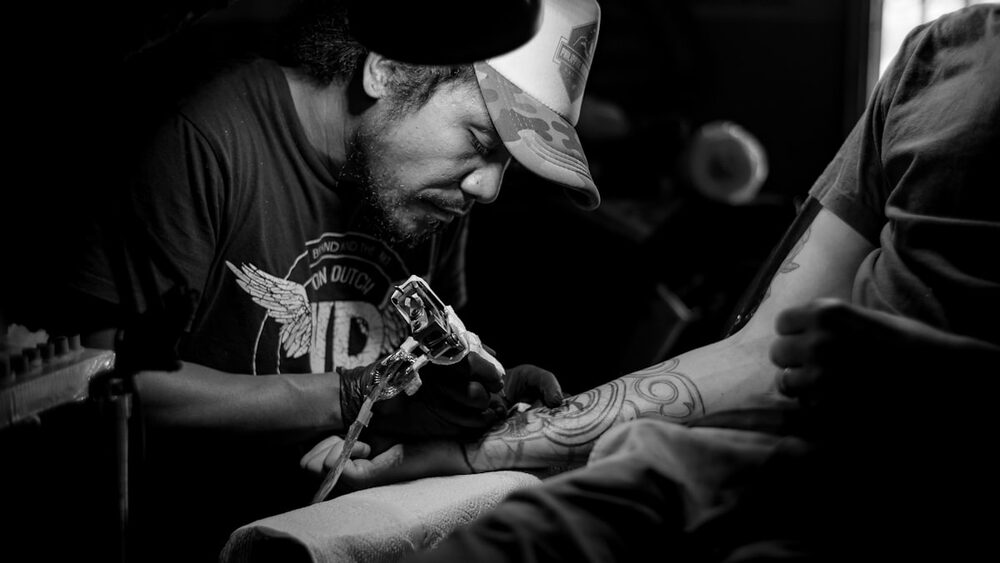 Tattoo artist at work in the studio