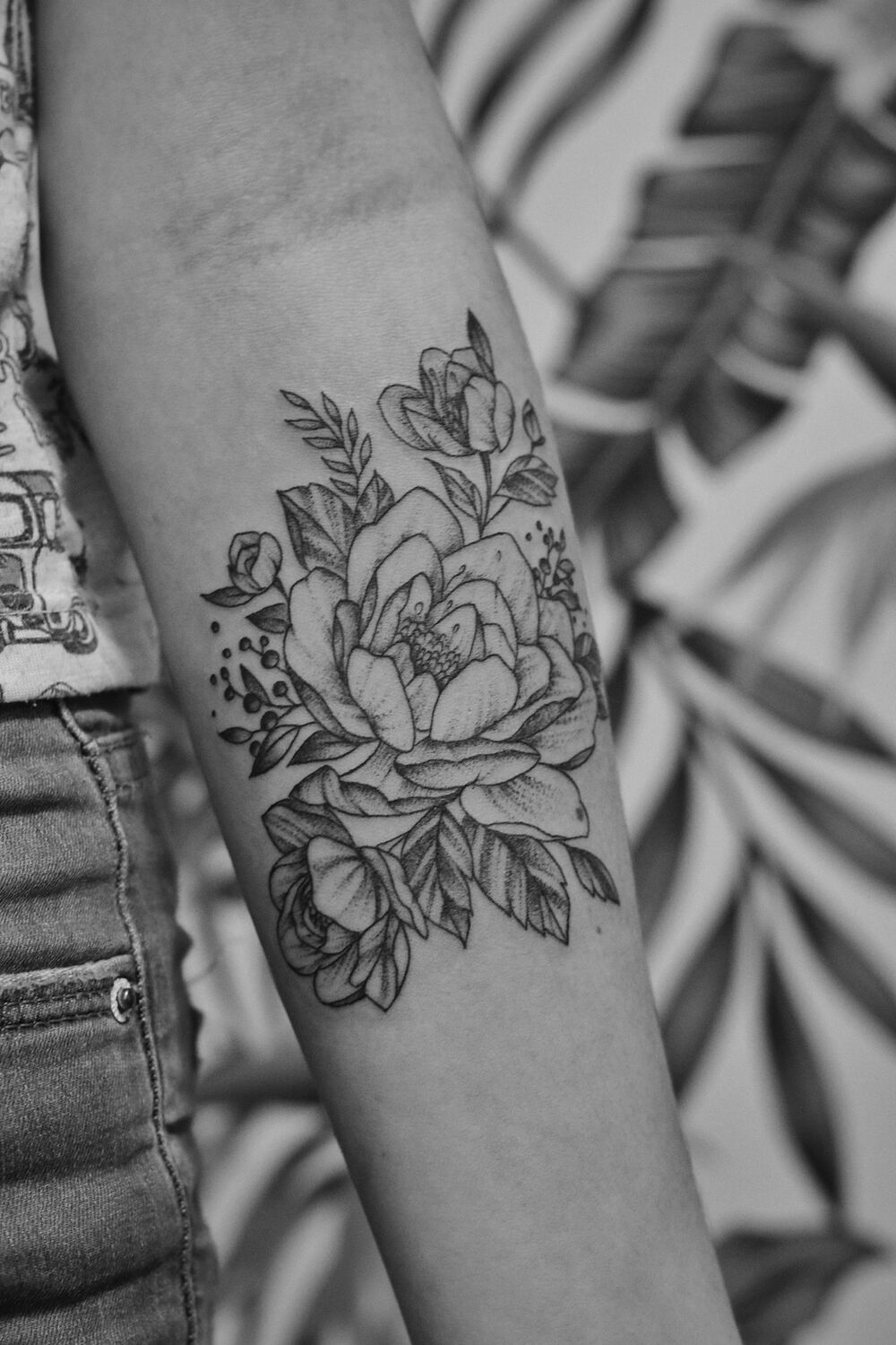 Fine-line floral forearm tattoo